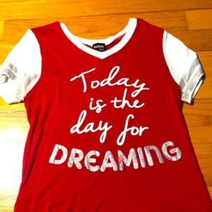 A red shirt with white words and a big grey word